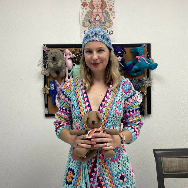 Katina, founder of Craft Studio Katina and Love, holding a handmade teddy bear